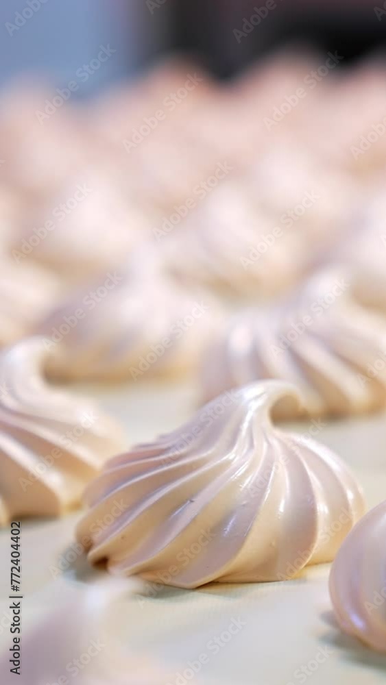 Fresh creamy marshmallows moving along the conveyor belt at the confectionery factory. Close up. Blurred background. Vertical video Fresh creamy marshmallows moving along the conveyor belt at the confectionery factory. Close up. Blurred background. Vertical video