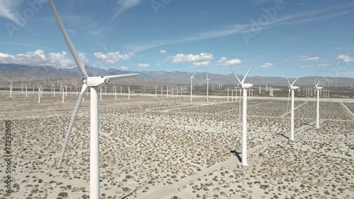 4K Aerials of the windmill farm in Palm Springs, California at the foot of the San Jacinto Mountains, adjacent to Highway 111, which helps provide energy for the Coachella Valley in Riverside County.