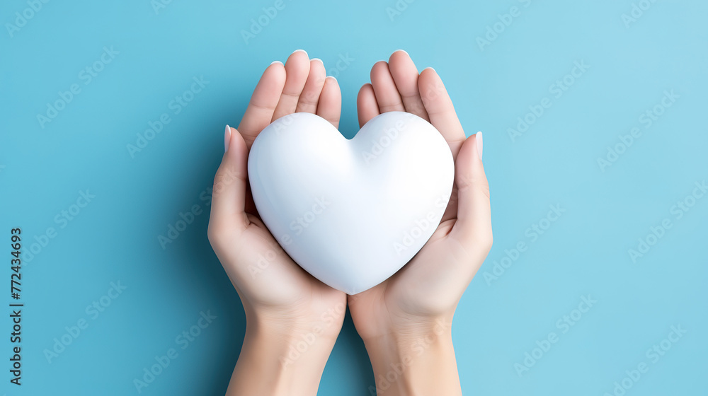 Hands of parents and a child surround a white heart on a blue background Hands of parents and a child surround a white heart on a blue background