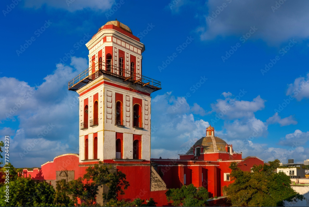 Vibrant Red and White Tower with a Dome, Exemplifies Colonial Architecture.