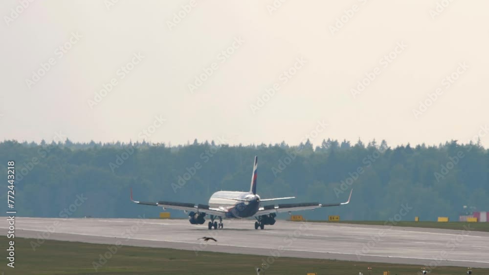 Jet airplane braking after landing at Moscow airport, rear view. Passenger flight arriving Jet airplane braking after landing at Moscow airport, rear view. Passenger flight arriving