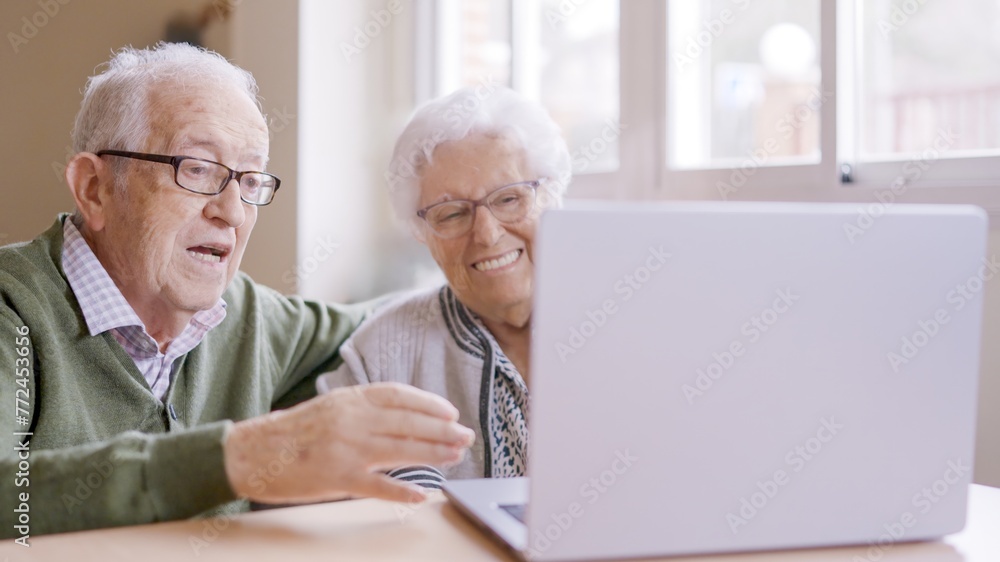Senior people talking during online meeting using laptop in geriatric