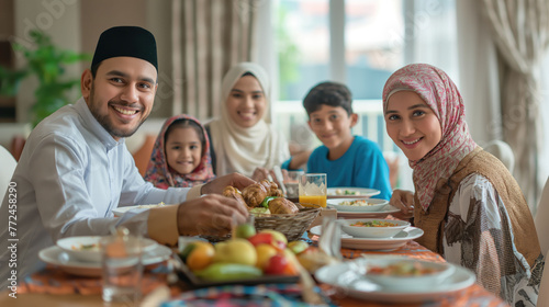 Family gathered around table for the iftar meal in Ramadan