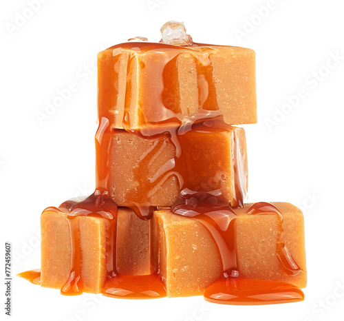 Pieces of salty caramel candy topped with melted sauce and sea salt crystals isolated on a white background