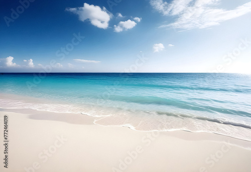 a beach with a blue sky and the ocean in the background