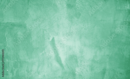 green mint plaster concrete wall texture use as background. premium green wallpaper with copy-space. background and texture of bare concrete wall. premium urban wallpaper.