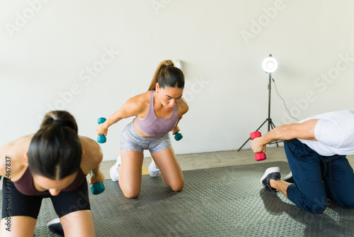 Vászonkép Group of people lifting weights during a gym class