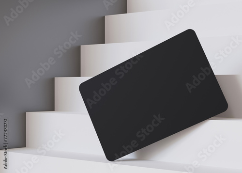 Stylish black business card mockup on a cascading white staircase, perfect for a bold and modern branding presentation. European size, 3,25 x 2,17 inch. Visiting, name card. Rounded corners. 3D. photo