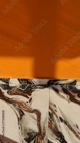patterned floor tiles and orange wall