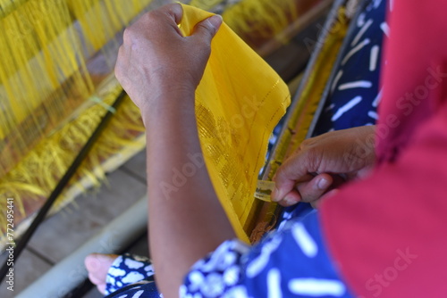 weaving craftsmen who is weaving cloth using traditional looms in donggala, Indonesia. photo