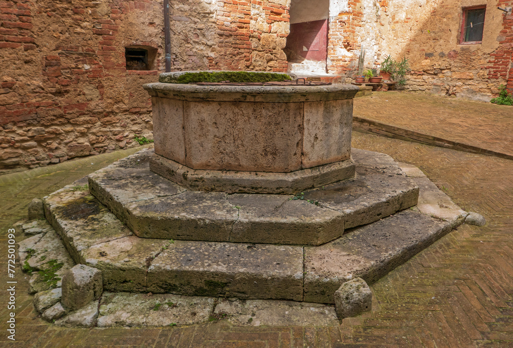 characteristic stone well in a Tuscan village characteristic stone well in a Tuscan village