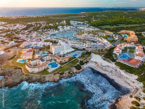 Aerial drone view of the harbor and the beach of Cala en Bosc, Menorca.