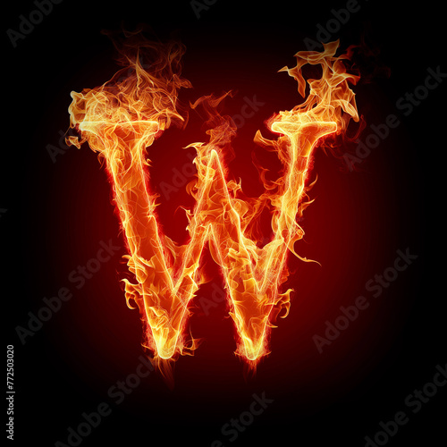 Letter W made of fire flames with sparks isolated on black background