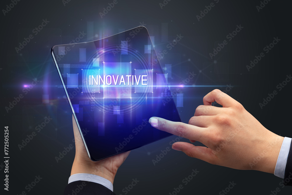 Businessman holding a foldable smartphone Businessman holding a foldable smartphone
