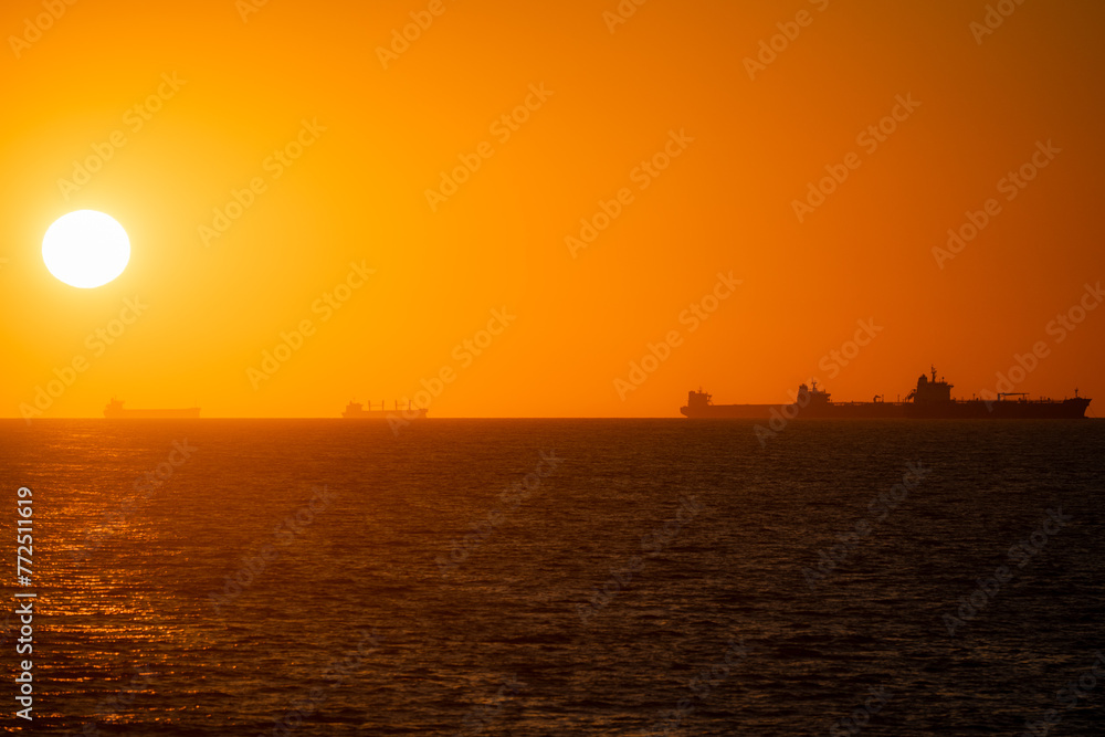 Ocean sunset with ship silhouettes Ocean sunset with ship silhouettes