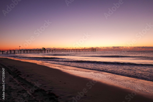 Early morning dramatic sunrise over the ocean and long pier