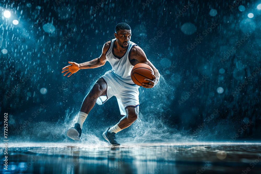 Handsome basketball player with a ball in action on floodlight professional basketball court. Handsome basketball player with a ball in action on floodlight professional basketball court.