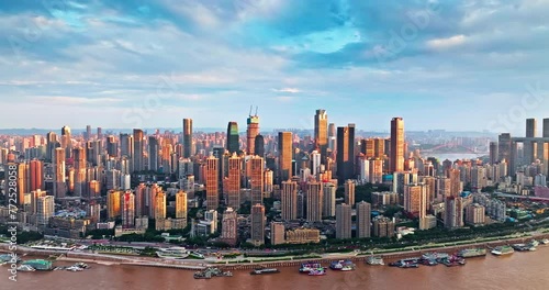 Aerial panning shot of Chongqing city center buildings skyline and river natural landscape at sunset photo