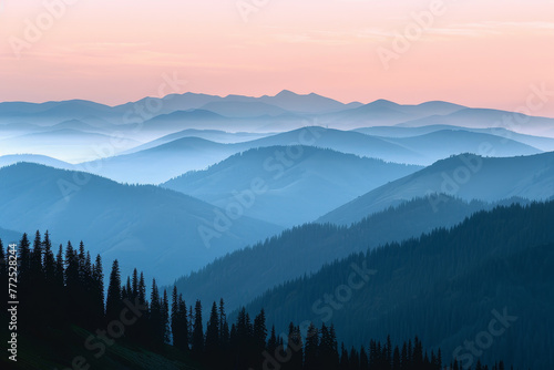 The mountains are covered in trees and the sky is a beautiful shade of pink