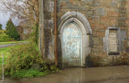 Ancient flooded building with a painted door 