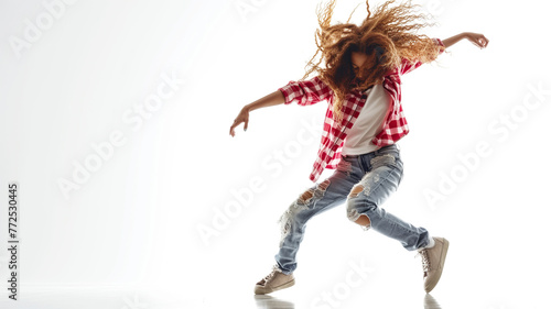 A young hip hop female dancer is dancing on a white background