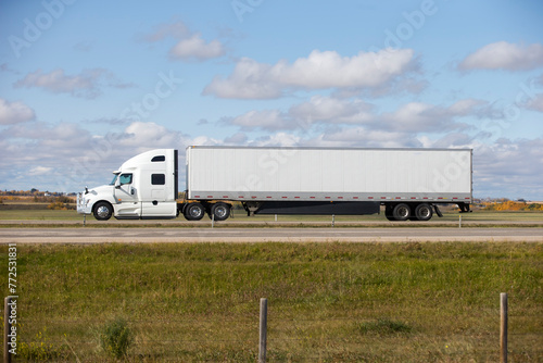Heavy Cargo on the Road. A truck hauling freight along a highway. Taken in Alberta, Canada