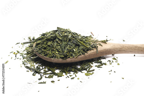 Sencha green tea pile in wooden spoon isolated on white, side view