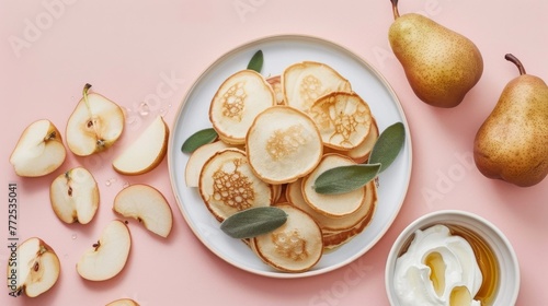  A plate of sliced pears, next to a bowl of yogurt and a bowl of honey on a pink table