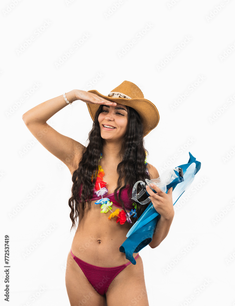 Young Latin woman in bikini holding diving fins, shielding eyes from summer sun on white background Young Latin woman in bikini holding diving fins, shielding eyes from summer sun on white background