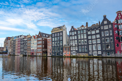 Amsterdam downtown - Amstel river, old houses and a bridge. Travel to Europe. Holland, Netherlands, Europe.