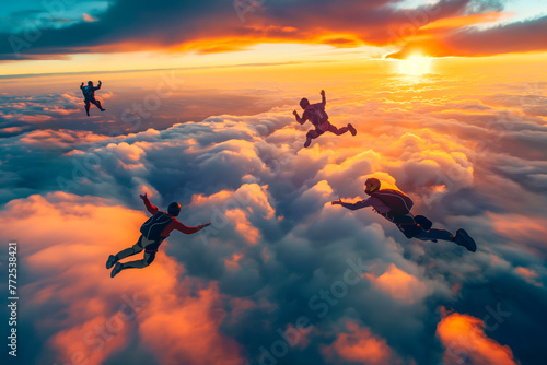 Skydiving group at the sunset Skydivers make a formation above the clouds photo