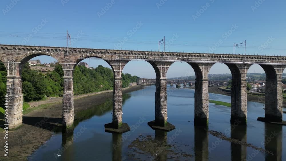 Drone flying under the Royal Border Bridge towards Royal Tweed Bridge in Northumberland, England, UK Drone flying under the Royal Border Bridge towards Royal Tweed Bridge in Northumberland, England, UK