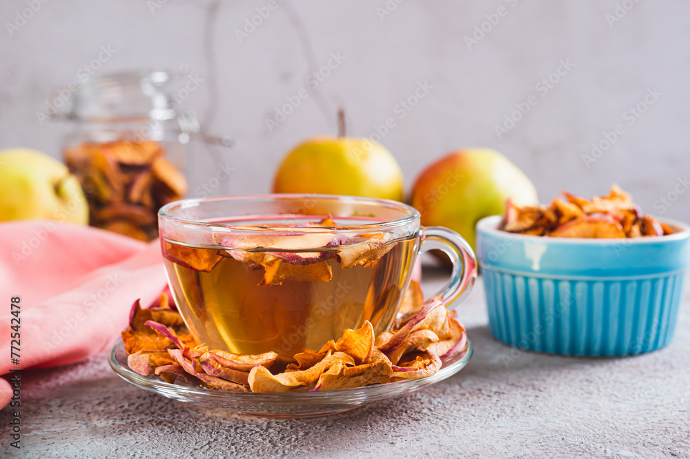 Delicious compote of aromatic dried apples in a cup on the table Delicious compote of aromatic dried apples in a cup on the table