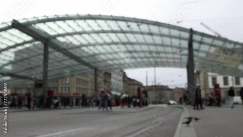 People and cyclists on main tram station in Bern, Switzerland, blurred background establisher