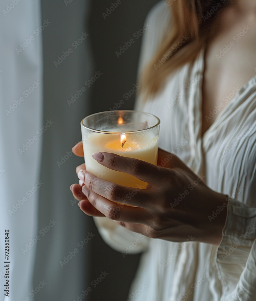 Female hands holding a candle Female hands holding a candle