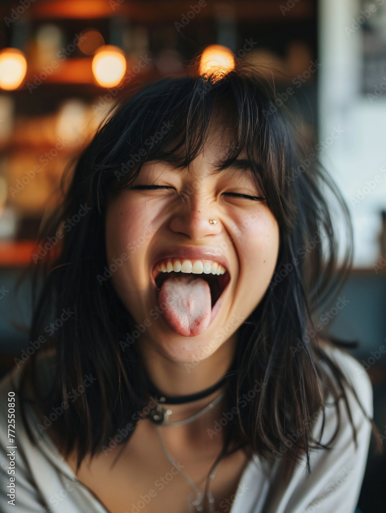 happy asian woman sticking tongue out happy asian woman sticking tongue out