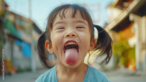 happy asian girl sticking tongue out