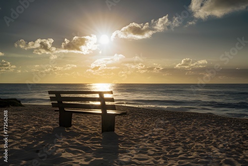 Bench bathed in sunlight offers a serene spot on the beach