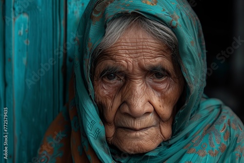 very sad, tired and wrinkled old woman looking at the camera