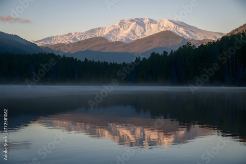 Tranquil sunrise illuminates the serene beauty of the lake