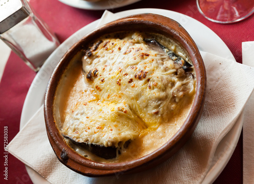 Appetizing baked eggplants stuffed with meat in bechamel sauce sprinkled with grated cheese. Traditional dish of Spanish cuisine ..