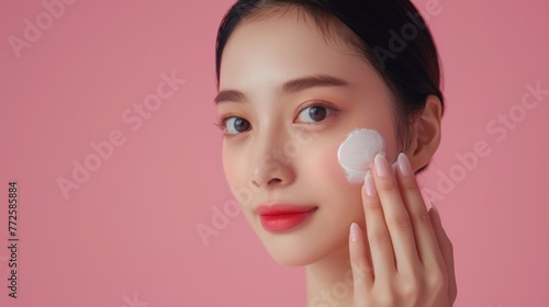 Young asian woman using cosmetic cream wallpaper background