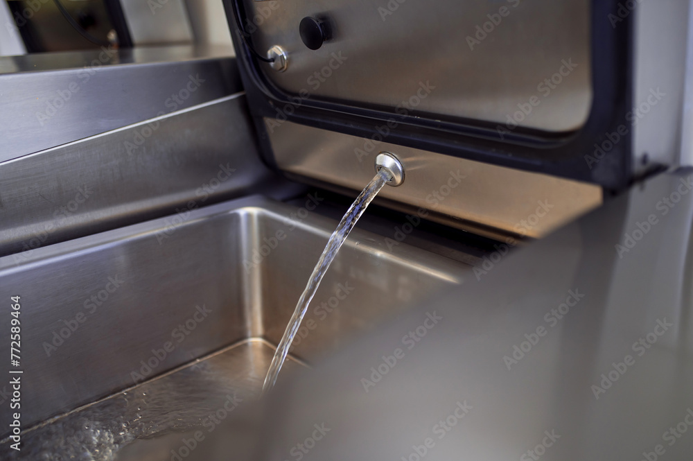 Industrial dishwasher in restaurant kitchen washing dishes Industrial dishwasher in restaurant kitchen washing dishes