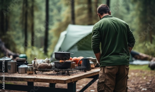 Man Preparing Food at Campsite in Forest