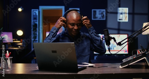 Portrait of african american man starting live broadcast on streaming platform, greeting viewers. Cheerful internet star arriving in studio, ready to create content for his audience