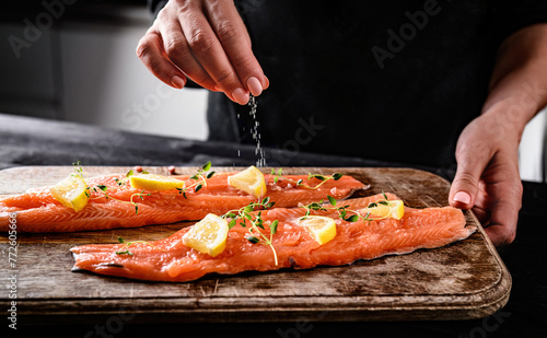 Photography Chief Salting With A Pinch Of Salt Raw Red Trout Fish For Cooking