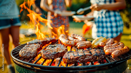 Steaks and hamburgers cooking on grill with flames in the background.