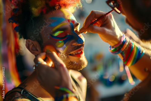 Gay couple doing each other´s make up, young men getting his face painted with pride colours for the pride parade
