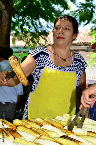 Close up of a street seller woman showing corn food