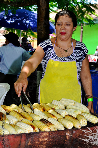 Close up of a street seller woman preparing corn food